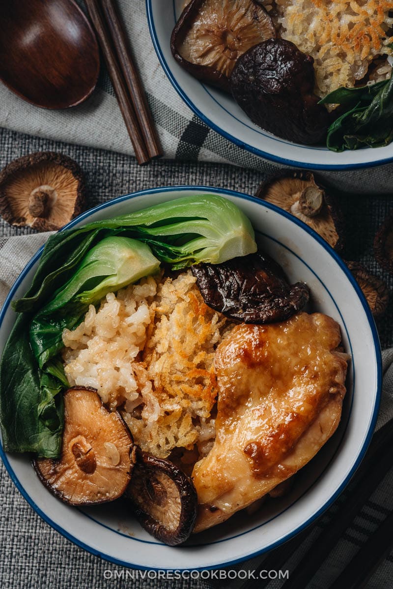 Clay Pot Chicken Rice - This clay pot chicken rice is so addictive! Beyond the greatness of the tender and moist chicken, the rice absorbs all the extract from the mushrooms and chicken grease, and is then seasoned with oyster sauce. It is SO good! My recipe teaches you the easiest way to create a super flavorful one-pot dinner without a clay pot or rice cooker. Clay pot chicken with rice, mushrooms, and baby bok choy