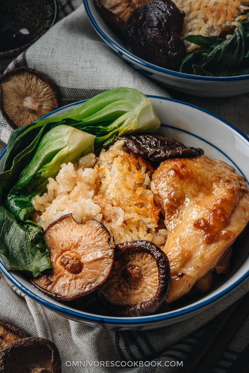 Clay Pot Chicken Rice - This clay pot chicken rice is so addictive! Beyond the greatness of the tender and moist chicken, the rice absorbs all the extract from the mushrooms and chicken grease, and is then seasoned with oyster sauce. It is SO good! My recipe teaches you the easiest way to create a super flavorful one-pot dinner without a clay pot or rice cooker. Clay pot chicken close up
