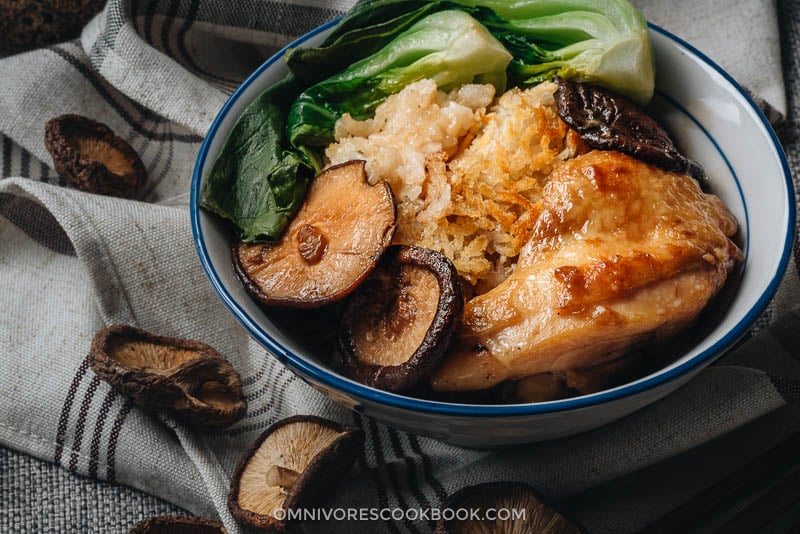 Clay Pot Chicken Rice - This clay pot chicken rice is so addictive! Beyond the greatness of the tender and moist chicken, the rice absorbs all the extract from the mushrooms and chicken grease, and is then seasoned with oyster sauce. It is SO good! My recipe teaches you the easiest way to create a super flavorful one-pot dinner without a clay pot or rice cooker. Chinese chicken dinner