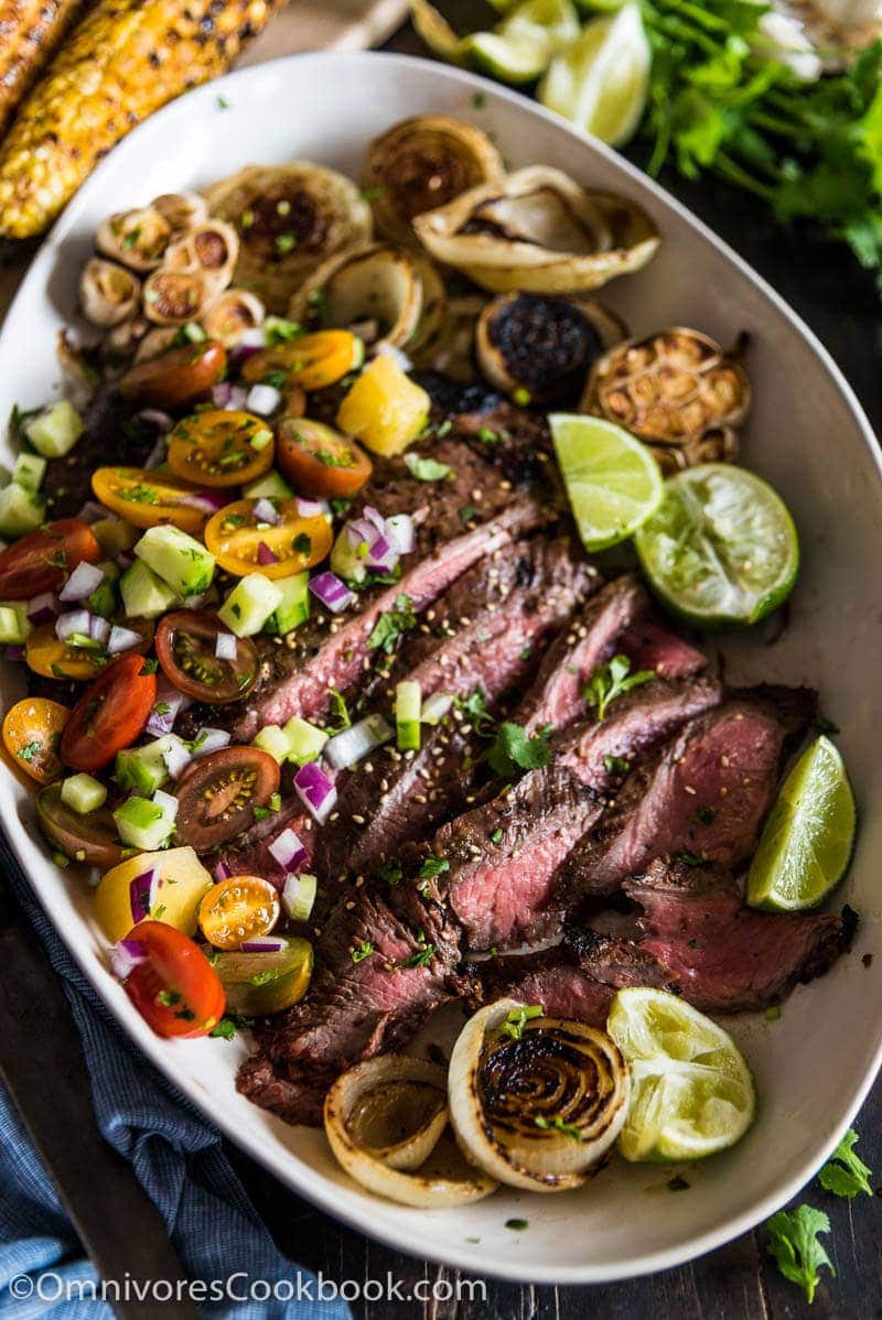 This recipe shares the secrets to creating the tenderest marinated flank steak that is bursting with flavor; included are salad and side dish ideas for an inexpensive dinner party.
