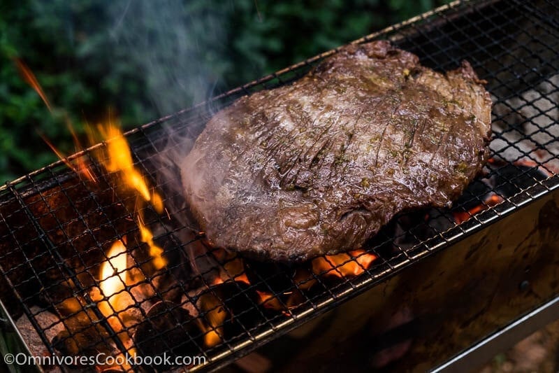 This recipe shares the secrets to creating the tenderest marinated flank steak that is bursting with flavor; included are salad and side dish ideas for an inexpensive dinner party.