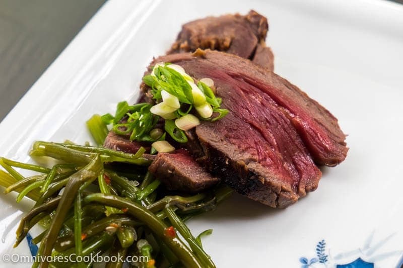 This recipe shares the secrets to creating the tenderest marinated flank steak that is bursting with flavor; included are salad and side dish ideas for an inexpensive dinner party.