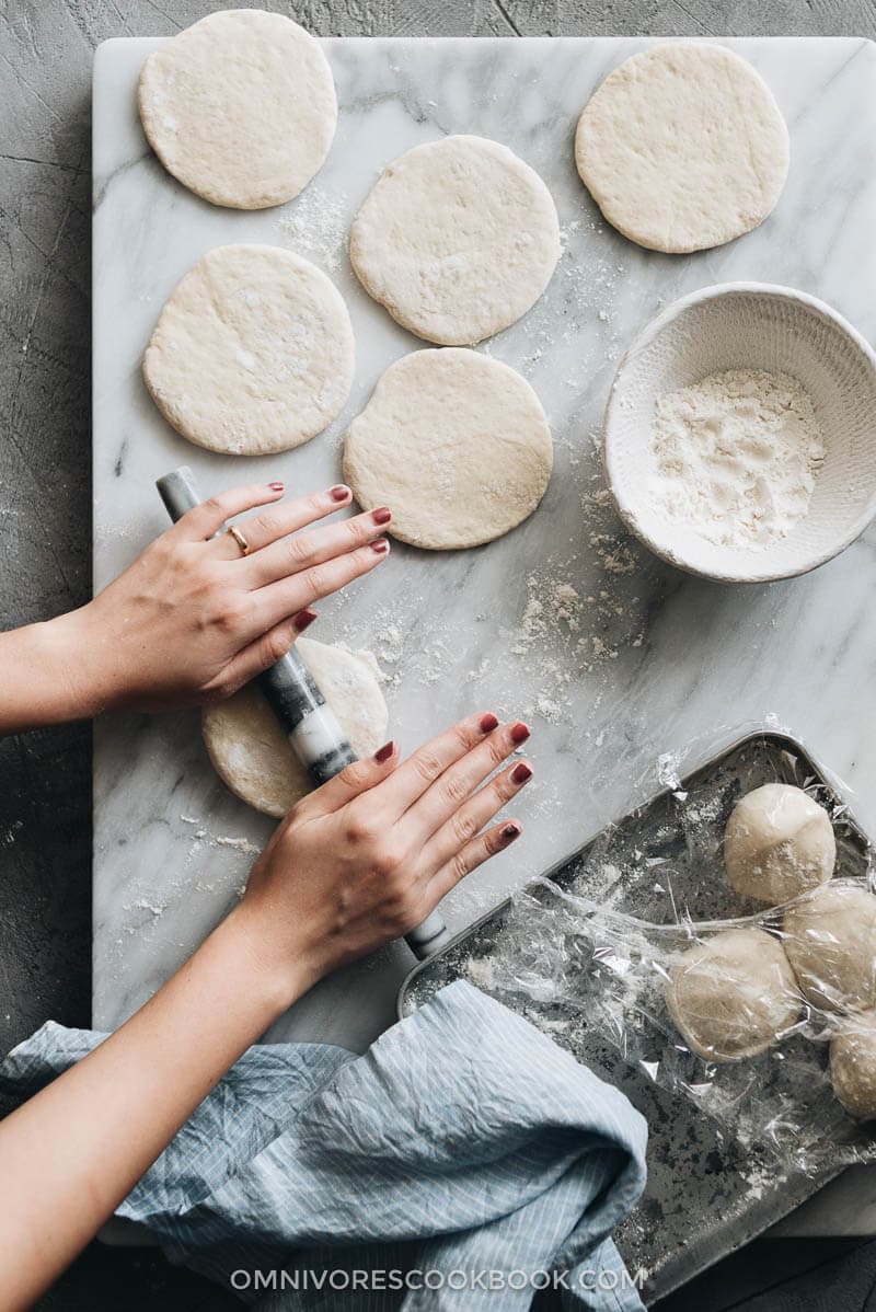 This super fast and easy flatbread recipe will totally blow your mind because it uses only 2 ingredients and 15 minutes of active cooking. You can use it to make pork belly buns or serve the bread with curry. So versatile! #vegetarian #vegan #bread #easy #recipes Kneading the dough for flatbread on marble board showing how to make flatbread
