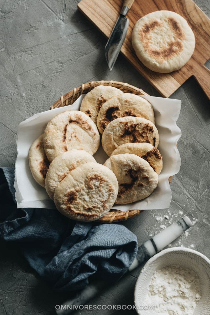 This super fast and easy flatbread recipe will totally blow your mind because it uses only 2 ingredients and 15 minutes of active cooking. You can use it to make pork belly buns or serve the bread with curry. So versatile! #vegetarian #vegan #bread #easy #recipes A dozen flatbreads served in bamboo basket