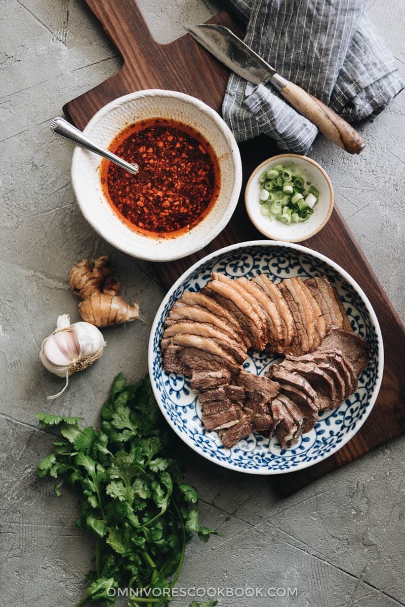 This Fu Qi Fei Pian (Sichuan Sliced Beef in Chili Sauce) recipe gives you the real-deal Sichuan experience. The tender beef slices are served in a rich, spicy hot sauce and topped with peanut flakes and cilantro. #glutenfree #beef #instantpot #chinese #recipes Sliced beef brisket and beef tongue with Sichuan chili sauce