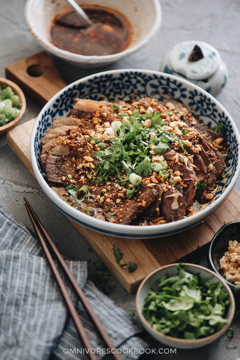 This Fu Qi Fei Pian (Sichuan Sliced Beef in Chili Sauce) recipe gives you the real-deal Sichuan experience. The tender beef slices are served in a rich, spicy hot sauce and topped with peanut flakes and cilantro. #glutenfree #beef #instantpot #chinese #recipes Fu Qi Fei Pian close up