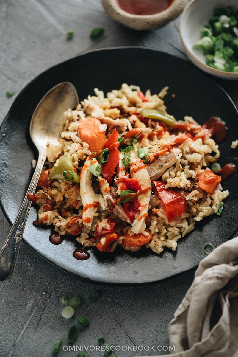 Instant Pot chicken and rice served with Sriracha sauce