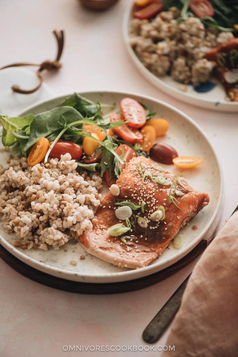 5-Ingredient Sous-Vide Salmon with Asian Sauce - cooking moist, tender, and flaky salmon in a rich Asian sauce without marinating. #ad #FoodSaverSousVide #simple #fillet #recipes #healthy Sous-vide salmon with Asian sauce served with brown rice and salad close up