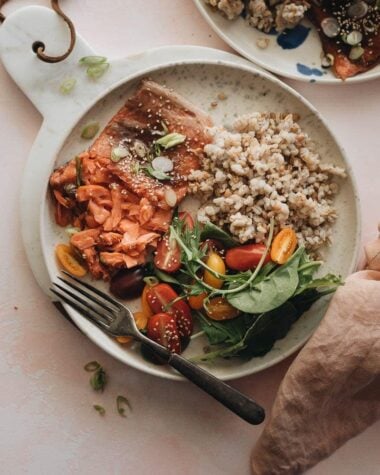 Moist flaky sous-vide salmon with Asian sauce served with brown rice and salad