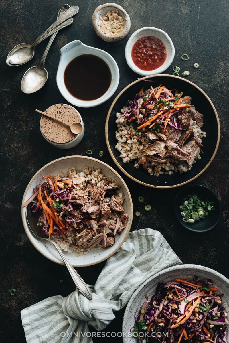 Asian-Style Instant Pot Pulled Pork - Tender, juicy pork with a melt-in-your-mouth texture made in a rich Asian sauce. It’s just about everything you need for a weekday dinner because it takes no time to put together. #easy #glutenfree #recipe #shoulder Asian Instant Pot pulled pork served on steamed brown rice with sauce on the side