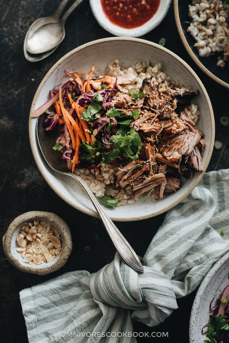 Asian-Style Instant Pot Pulled Pork - Tender, juicy pork with a melt-in-your-mouth texture made in a rich Asian sauce. It’s just about everything you need for a weekday dinner because it takes no time to put together. #easy #glutenfree #recipe #shoulder Asian Instant Pot pulled pork served on steamed brown rice and coleslaw