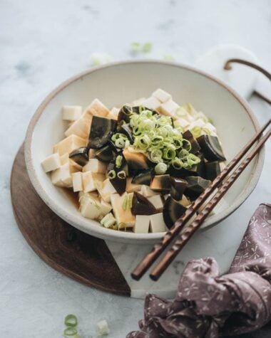 Century egg with tofu salad garnished with green onions