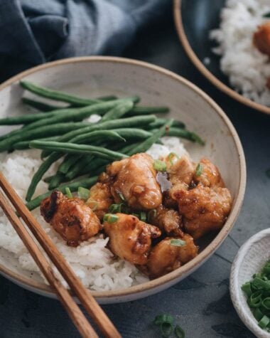 Homemade crispy Chinese honey chicken served in bowls close up