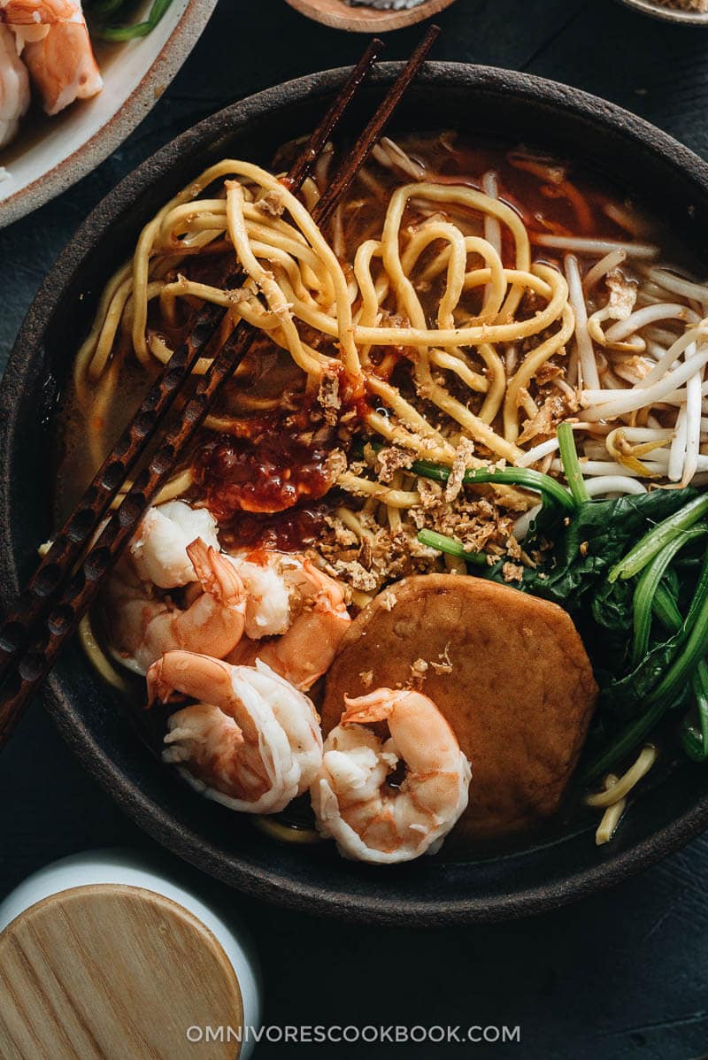 Hokkien Prawn Mee Noodle Soup (Hae Mee) - Tender yellow noodles in a rich savory-sweet red-orange broth served with juicy prawns, fish cakes, crunchy bean sprouts, and crispy fried shallots. {Gluten-Free adaptable} Hokkien Prawn Mee Noodle Soup (Hae Mee) close up
