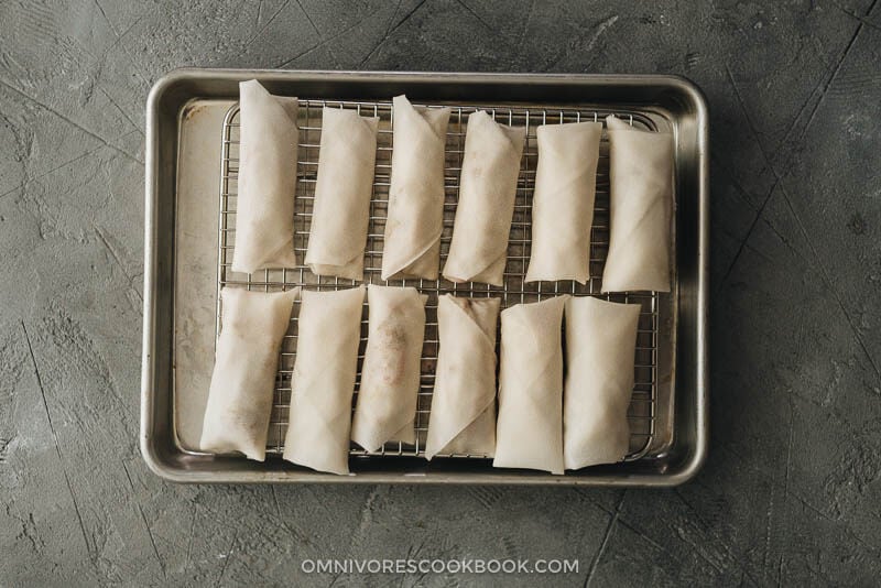 Chinese egg rolls - The ultimate guide to making restaurant-style egg rolls at home. These Chinese egg rolls are filled with tender meat and crunchy vegetables. I’ve included three cooking methods in this recipe and all of them yield a very crispy crust. Make them ahead and serve them as an appetizer at your dinner party or as a snack. #dimsum #takeout Uncooked Chinese egg rolls