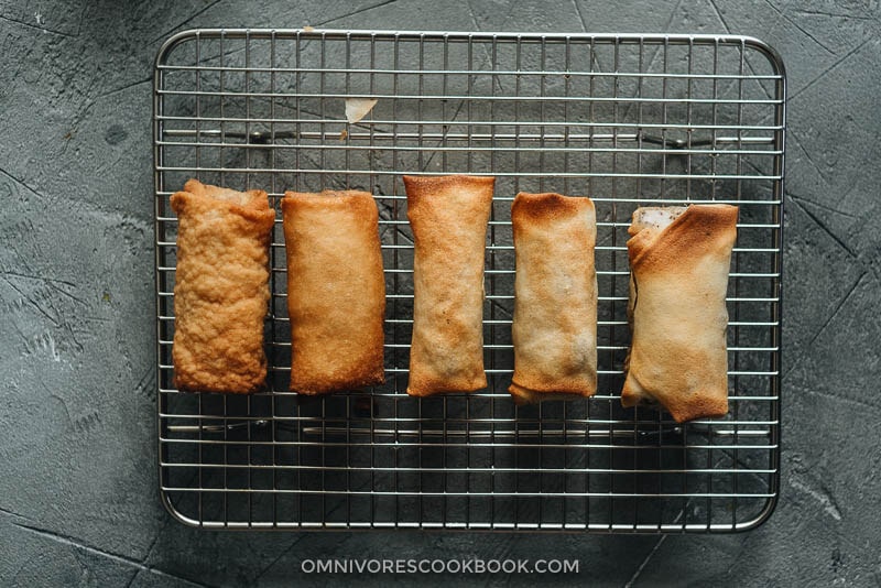 Chinese egg rolls - The ultimate guide to making restaurant-style egg rolls at home. These Chinese egg rolls are filled with tender meat and crunchy vegetables. I’ve included three cooking methods in this recipe and all of them yield a very crispy crust. Make them ahead and serve them as an appetizer at your dinner party or as a snack. #dimsum #takeout Compare Chinese egg rolls that are deep fried and cooked in an air fryer