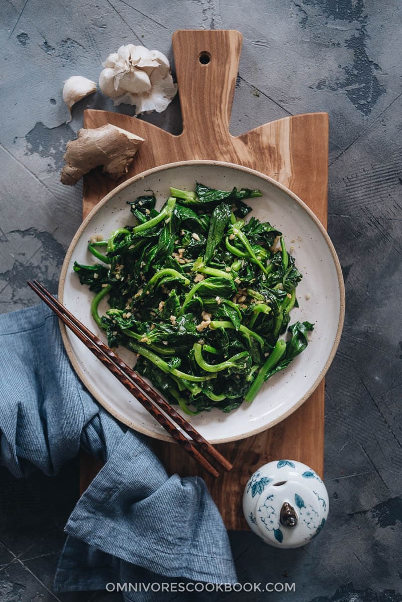 Stir-Fried Pea Shoots with Garlic - Tender crisp stir-fried pea shoots with plenty of aromatics to create a mouth-watering dish that you can’t stop eating. The post includes all the notes and tips to walk you through the process step-by-step to create a restaurant-style result. {Vegan, Gluten-Free adaptable} Homemade stir-fried pea shoots with garlic