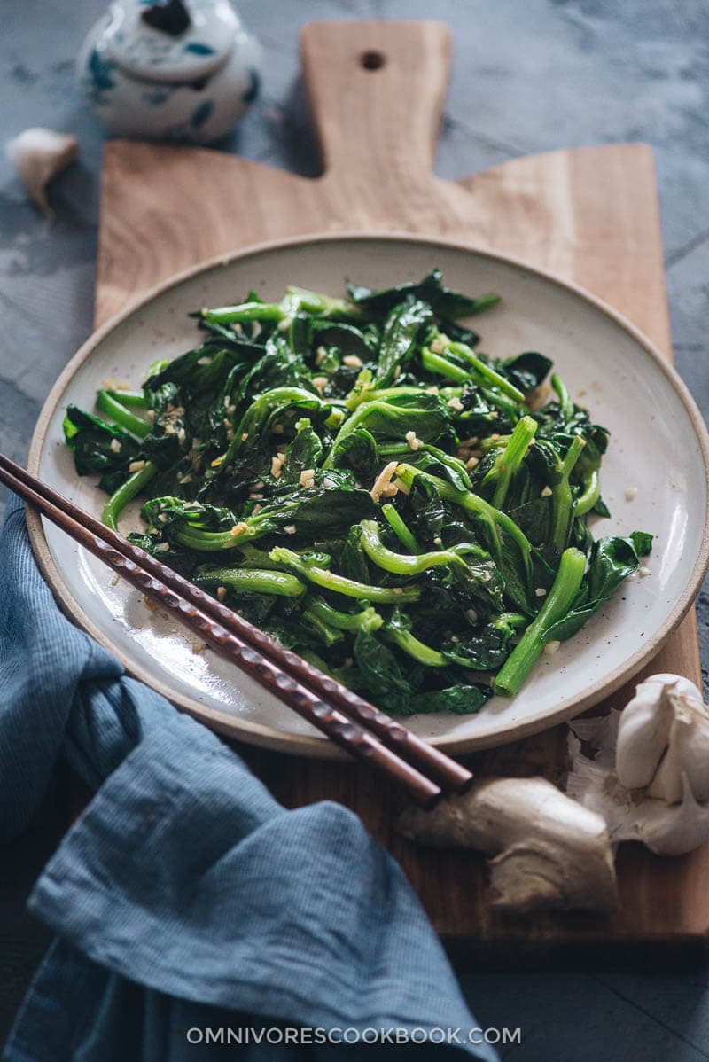 Stir-Fried Pea Shoots with Garlic - Tender crisp stir-fried pea shoots with plenty of aromatics to create a mouth-watering dish that you can’t stop eating. The post includes all the notes and tips to walk you through the process step-by-step to create a restaurant-style result. {Vegan, Gluten-Free adaptable} Homemade stir-fried snow pea shoots with garlic