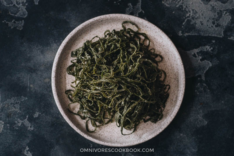 Chinese Seaweed Salad - Tender meaty seaweed salad served in a savory, sour, and garlicky sauce. It’s very easy to make and is a perfect cold appetizer to add nutrition to your meal in the summer. {Vegan} Fresh seaweed in a plate