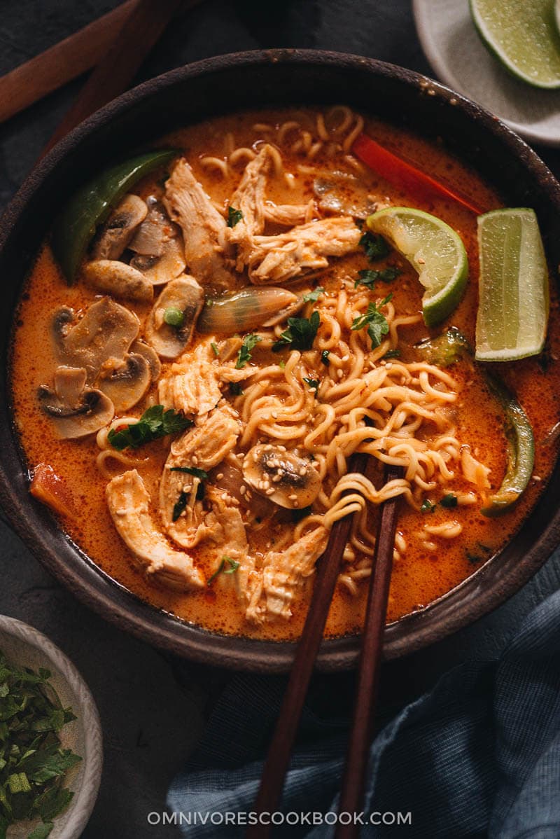 This Thai peanut butter ramen is a perfect dish for your weekday dinner. The tender noodles, juicy chicken and colorful veggies are soaked in a rich broth that is nutty, savory, spicy and sweet. It’s so easy to make and you can easily make it into a vegan version as well. Thai peanut butter ramen in a bowl close up