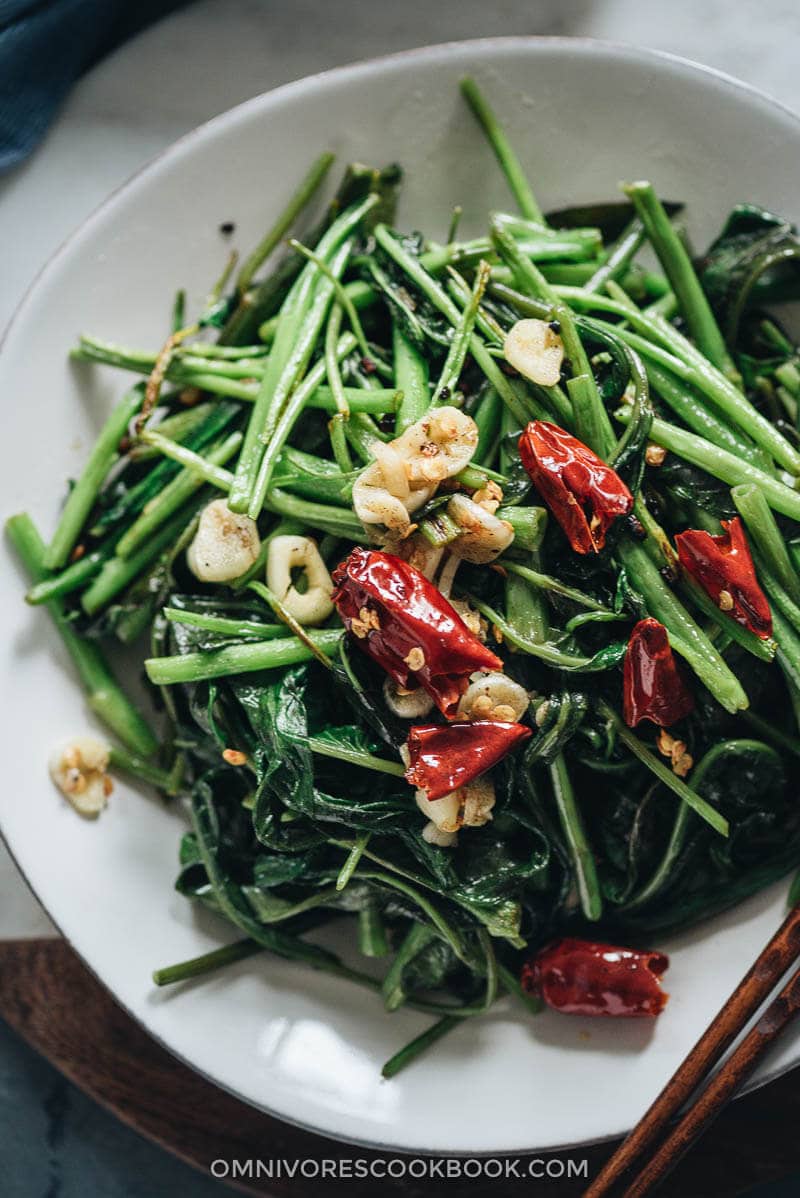 Stir-Fried Water Spinach - Two Ways | Introducing two ways to cook stir-fried water spinach, and both require fewer than five ingredients. Try out this Chinese leafy green to add color and nutrition to your dinner table. {Vegan, Gluten-Free} Stir fried water spinach close up