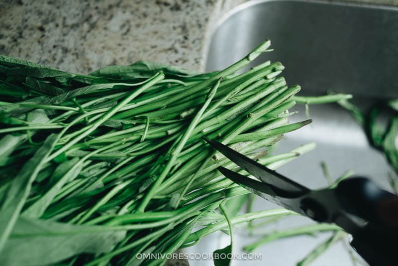 Stir-Fried Water Spinach - Two Ways | Introducing two ways to cook stir-fried water spinach, and both require fewer than five ingredients. Try out this Chinese leafy green to add color and nutrition to your dinner table. {Vegan, Gluten-Free} Prepare water spinach before cooking