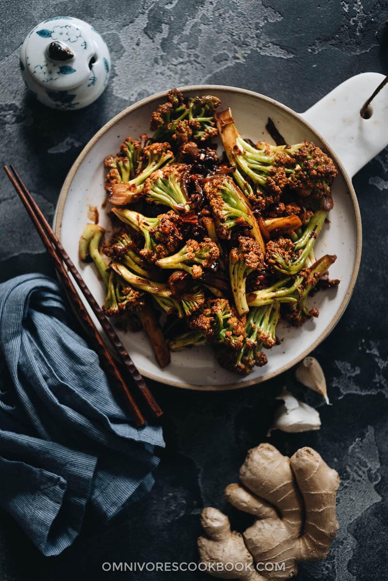 Chinese Cauliflower Stir Fry (干锅菜花) - These crunchy cauliflower bites are cooked in a numbing spicy sauce that is so rich. Even though this recipe is vegan, I’ve included notes on how to add different types of protein, to make a more substantial dish for your dinner. {Vegan, Gluten-Free Adaptable} Sichuan cauliflower dry pot served in plate