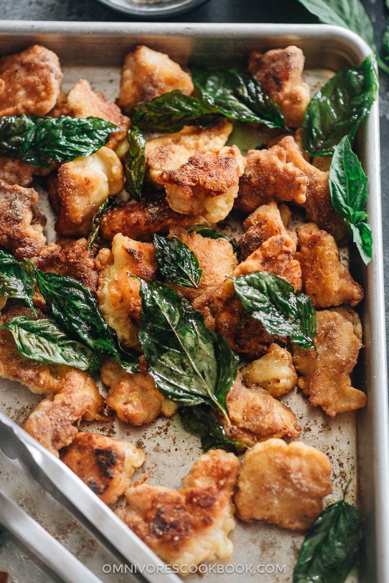 Taiwanese salt and pepper chicken - This recipe uses minimal oil to create the most scrumptious result. These chicken bites are super crispy, juicy, and bursting with flavor. {Gluten-Free} Homemade salt and pepper chicken served in a tray