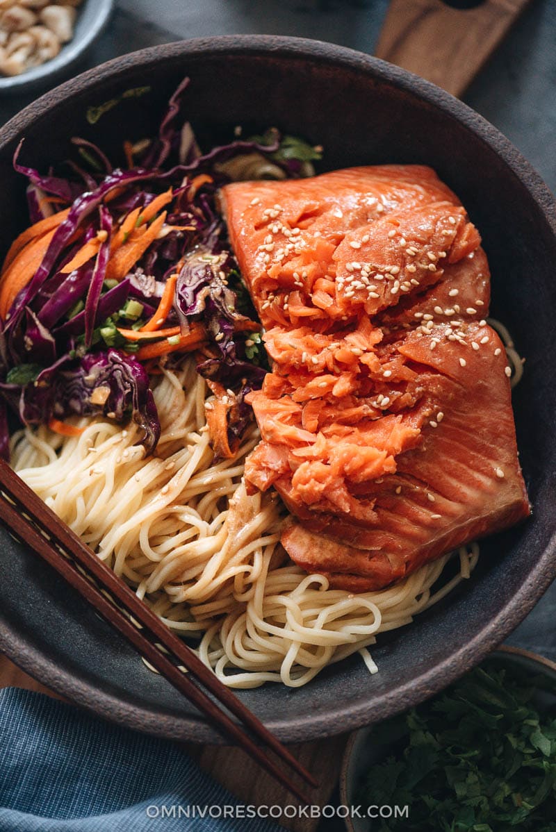 30-Minute Salmon Noodle Bowl with Coleslaw - Tender flaky juicy baked salmon served on noodles with coleslaw in a garlicky gingery savory sauce that’s lightly sweet. This recipe uses a blender to mix one sauce that is used as the salmon marinade and in the noodle sauce, so it literally takes 10 minutes to get ready. It’s a perfect dish for your busy weekday dinners and meal-prep. {Gluten-Free Adaptable} Noodles with flaky salmon on top