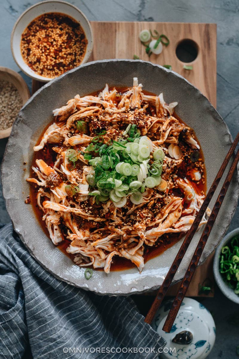 Chinese Bang Bang Chicken (棒棒鸡) - The real-deal Sichuan version of Bang Bang chicken made with juicy tender shredded chicken breast covered with a savory, nutty, spicy sauce with a hint of tangy and sweet notes. Originally a traditional Chinese appetizer, make it ahead and serve it at your next movie night or game day party. Mind blow guaranteed. Sichuan-style shredded chicken in red oil