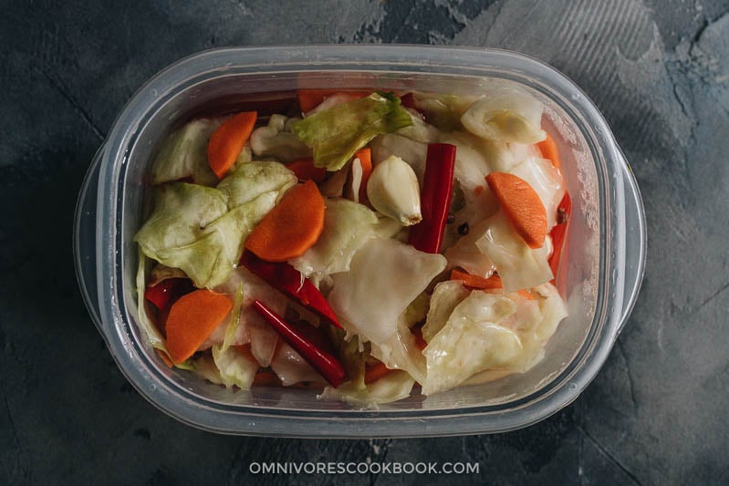 Chinese Pickled Cabbage (A Quick Pickle Recipe) | Make crunchy Chinese pickled cabbage with this quick pickle recipe. It is so easy to prepare, and the result is a well-balanced crisp sweet and sour pickle just like the appetizer you’d get at a Chinese restaurant. {Vegan, Gluten-Free} Sichuan pickled cabbage in a container