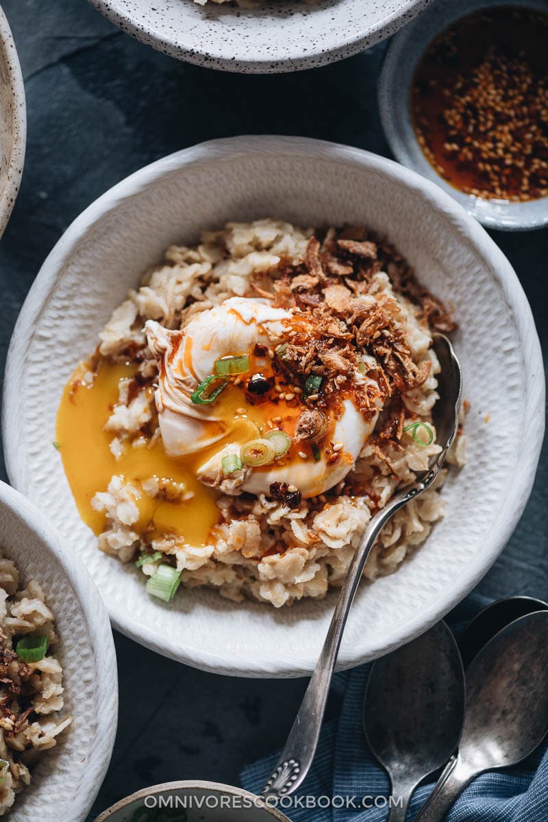 5-Ingredient Savory Oatmeal (Chinese-Style) | This oatmeal is simmered with chicken stock until creamy, topped with runny eggs, seasoned with soy sauce and chili oil, and finished up with crispy fried shallots. This breakfast dish is so easy to put together and the combo creates a bold taste with a beautiful texture. {Gluten-Free adaptable} Savory oatmeal in a bowl
