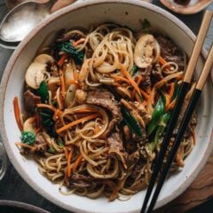 Japchae (Korean Sweet Potato Noodles) | Make japchae at home for a comforting, delicious, and nutritionally balanced weekday dinner. The tender sweet potato noodles are tossed with charred beef and crispy veggies in a sweet savory sauce. This easy recipe uses shortcuts to make the cooking process faster than the traditional recipe. {Gluten Free adaptable, vegan adaptable}