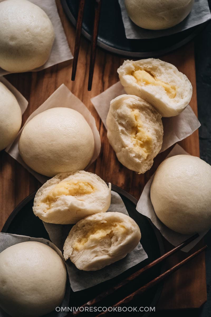 Chinese Steamed Custard Buns (nai wong bao, 奶黄包) | A dim sum classic, these buns are perfect for holiday gatherings and parties as well. Made with a yeast dough and steamed, the buns have a super soft and spongy texture with a smooth surface. The custard filling is creamy, fragrant, and sweet. The recipe includes detailed step-by-step pictures to help you recreate the restaurant-style custard buns in your own kitchen. Chinese steamed custard buns
