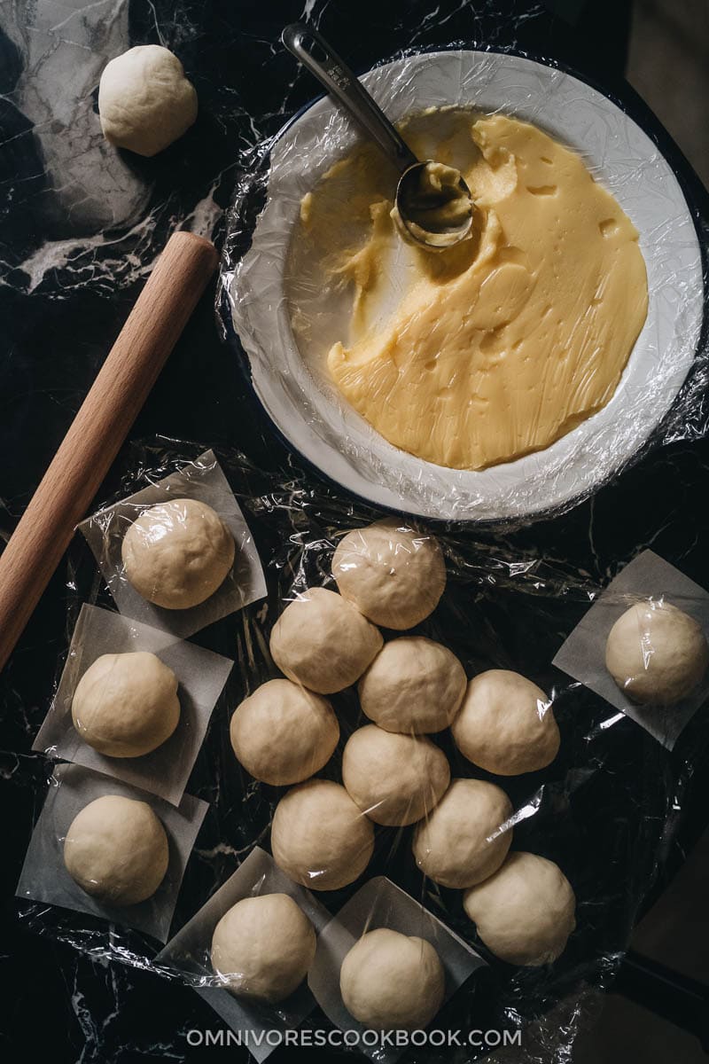 Chinese Steamed Custard Buns (nai wong bao, 奶黄包) | A dim sum classic, these buns are perfect for holiday gatherings and parties as well. Made with a yeast dough and steamed, the buns have a super soft and spongy texture with a smooth surface. The custard filling is creamy, fragrant, and sweet. The recipe includes detailed step-by-step pictures to help you recreate the restaurant-style custard buns in your own kitchen. Doughs and custard filling