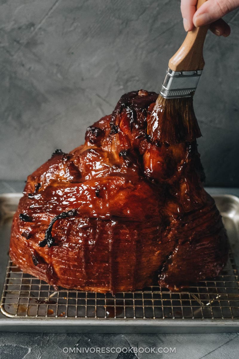 Asian Pineapple Glazed Ham | Try out this easy pineapple glazed ham if you want to make a traditional glazed ham with something new, while staying just as hearty and comforting. The glaze is made from brown sugar and pineapple juice, with a hint of gingery and garlicky taste, just like sweet chili sauce. It is a perfect centerpiece dish for holidays such as Christmas and Easter. {Gluten-Free Adaptable} Glazing roasted ham