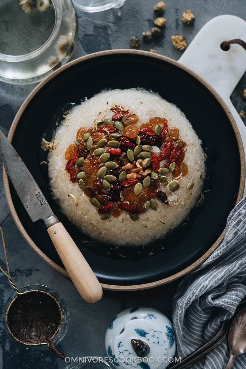 Eight Treasure Rice (八宝饭, Chinese Rice Pudding) | Lightly sweetened sticky rice stuffed with red bean paste and topped with dried fruits and seeds, then served with a fragrant chrysanthemum syrup that has an amazing earthy aroma. The modernized version tastes so good and uses ingredients that are easy to source. And the cooking is quite simple. It’s a light and healthy dessert that is perfect to serve at the end of a meal. {Vegan, Gluten-Free} Chinese eight treasure rice close-up
