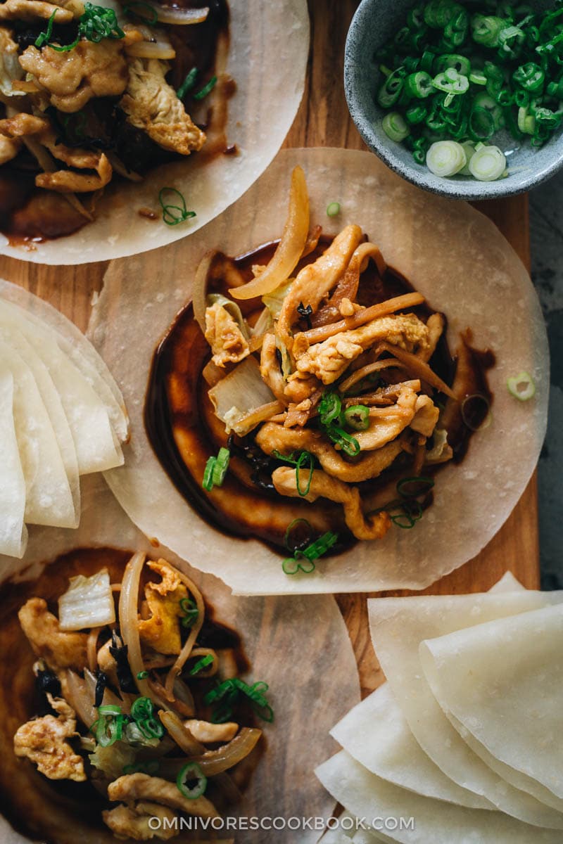 Moo Shu Chicken | A hybrid of authentic Chinese and American Chinese food, moo shu chicken makes a refreshing and delicious dish that’s better than the Chinese restaurant version. Tender juicy chicken, crisp napa cabbage, crunchy bamboo shoots, and wood ear mushrooms are quickly cooked in a savory and lightly sweet sauce. Serve either with moo shu wrappers or steamed rice and you’ll have a healthy and delicious meal. Moo shu chicken on moo shu wrapper