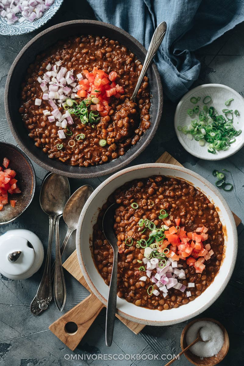 Lentil soup topped with chopped tomato and onion