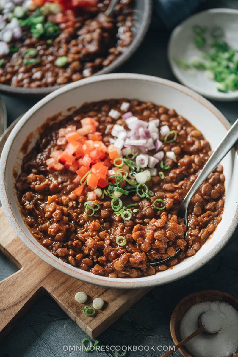 Lentil stew topped with chopped tomato and onion