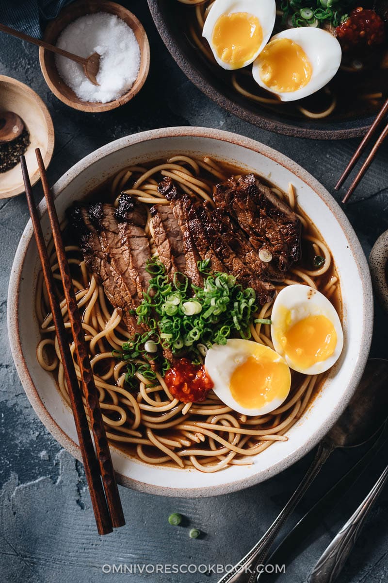 Yaka mein topped with eggs and steak