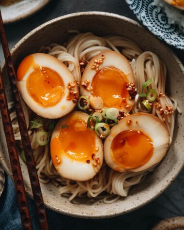 Marinated eggs on noodles with chili oil close-up