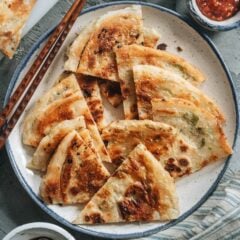 Super crispy and flaky on the outside and slightly chewy inside, my dim sum favorite, scallion pancakes, make a wonderful snack that you&rsquo;ll love! {Vegan}