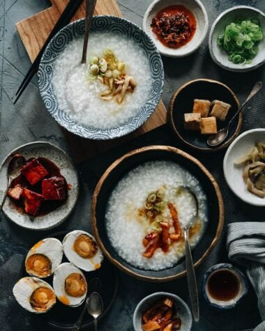 Plain congee topped with pickles, sesame oil and green onion
