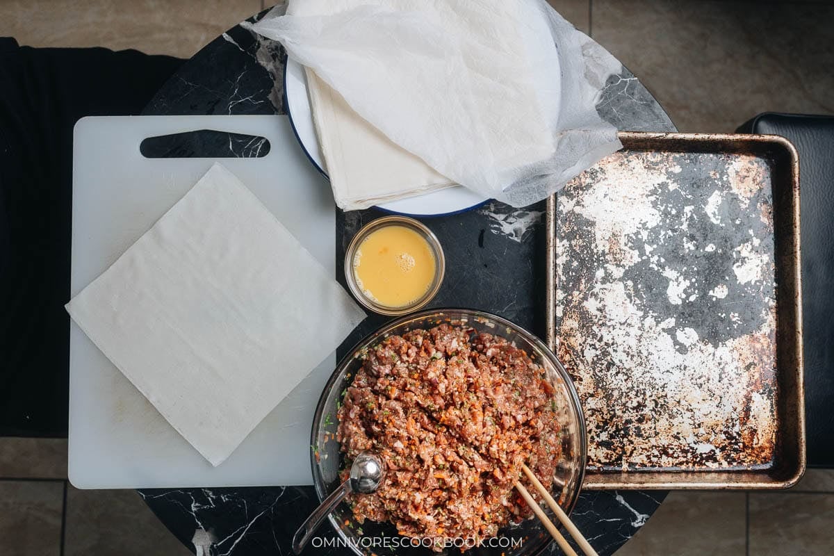 Setup with egg roll wrappers and egg wash.
