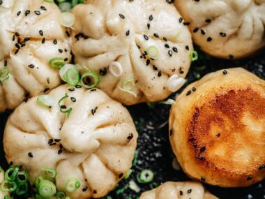 Sheng Jian Bao garnished with sesames and green onion