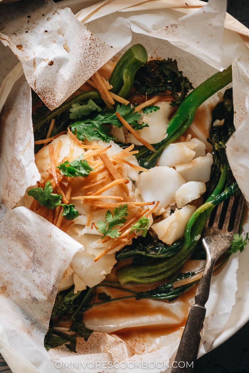Oven baked cod in paper with a gingery sesame sauce