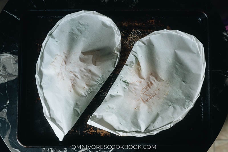 Fish wrapped in parchment paper and ready to bake