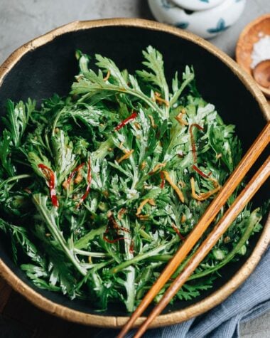 Chrysanthemum greens in a bowl with Asian dressing