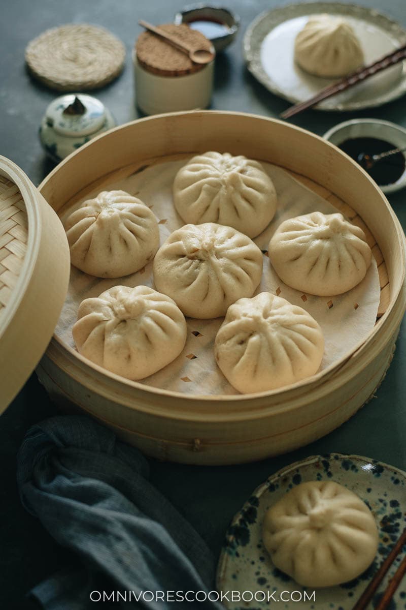 A bamboo steamer with Chinese steamed buns